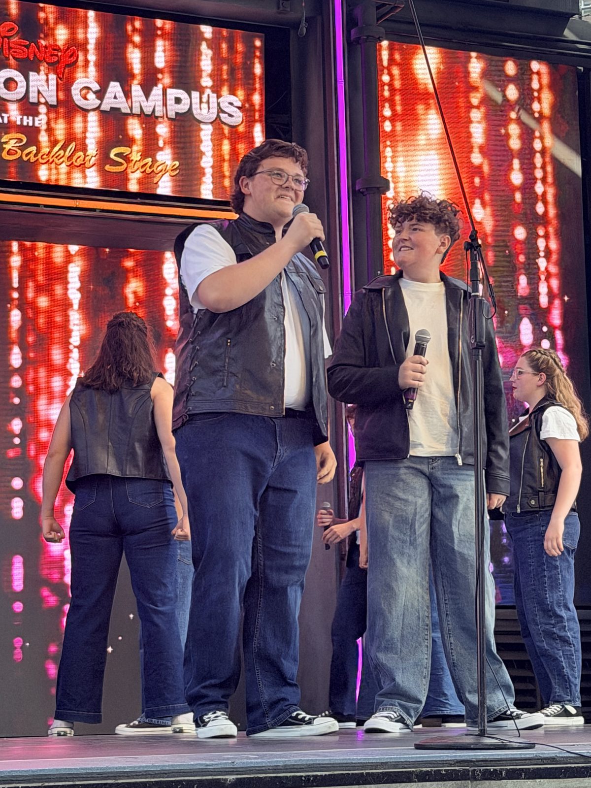 Two Aspire Young Artists sharing a featured vocal moment on stage