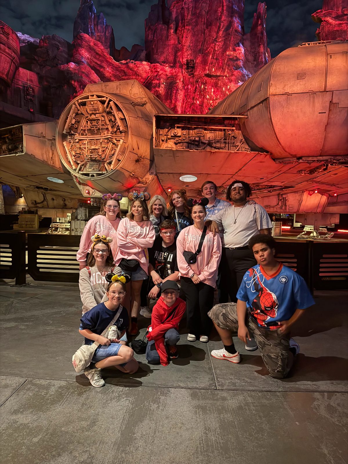The Traditions travel group gathered in Galaxy's Edge at night