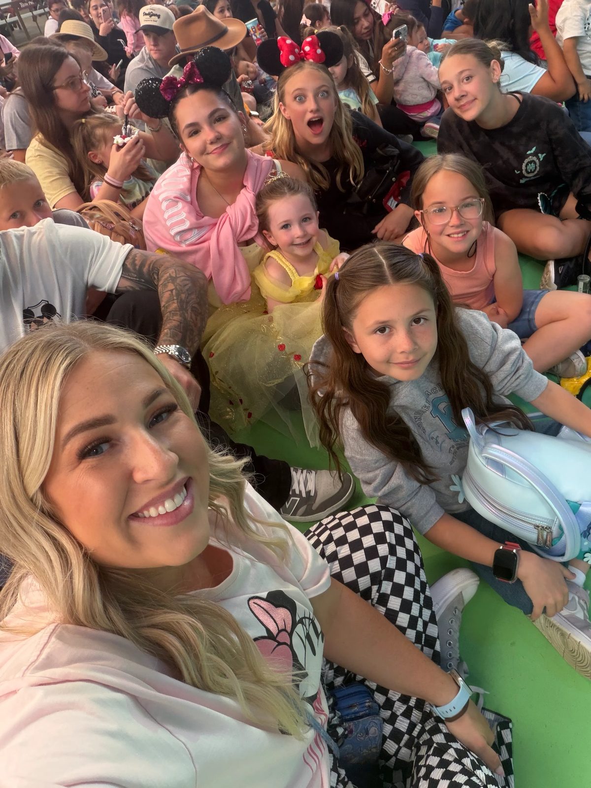 Aspire Young Artists and a mentor seated together in the audience at a park show