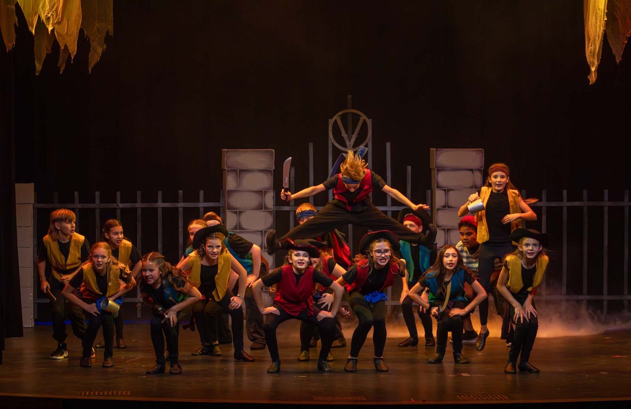 The full Aspire company on stage at Villains Night