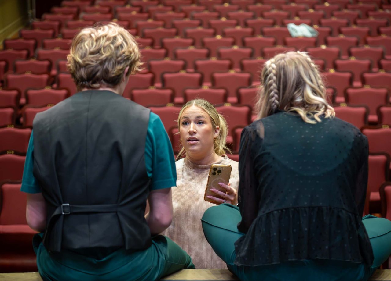 An Aspire director coaches performers in the house before a show