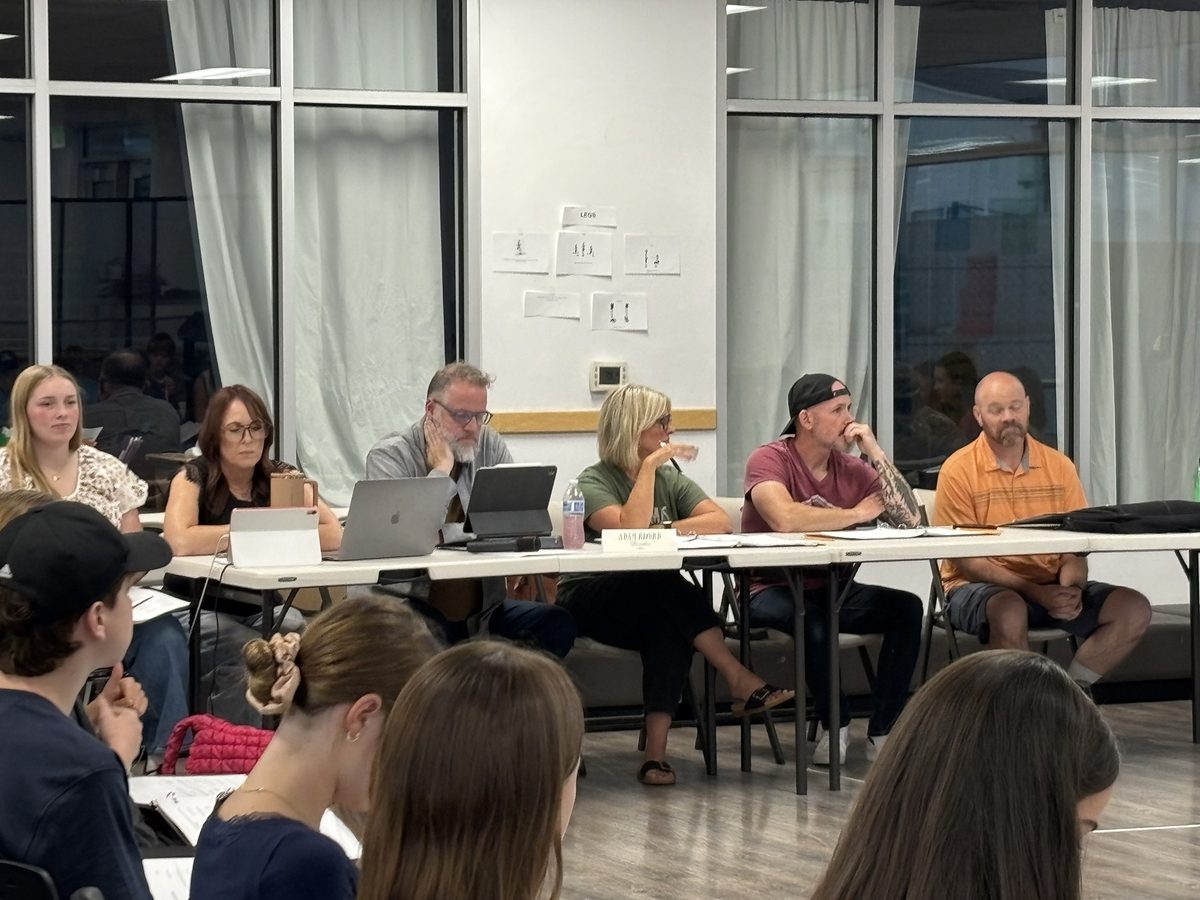 Encore&rsquo;s creative team seated at the table during a read-through of A Christmas Carol