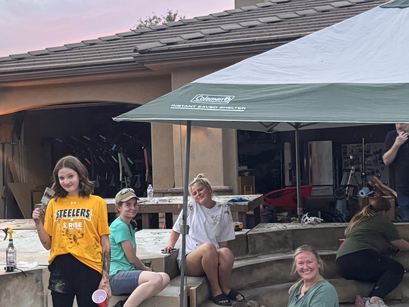 The team taking a break at sunset after a night of building