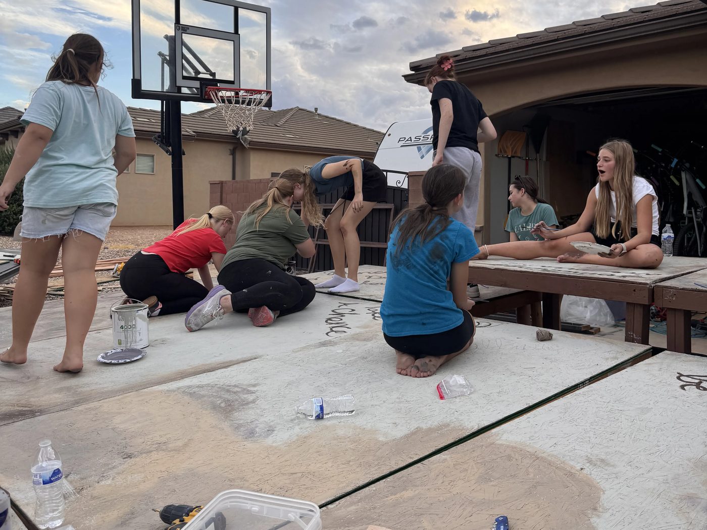 Volunteers and Young Artists working together on the set
