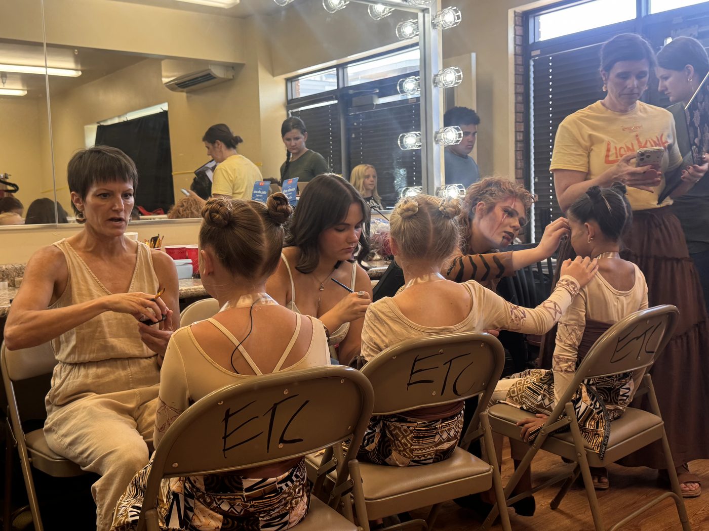 Volunteers and Young Artists fill the dressing room before a performance