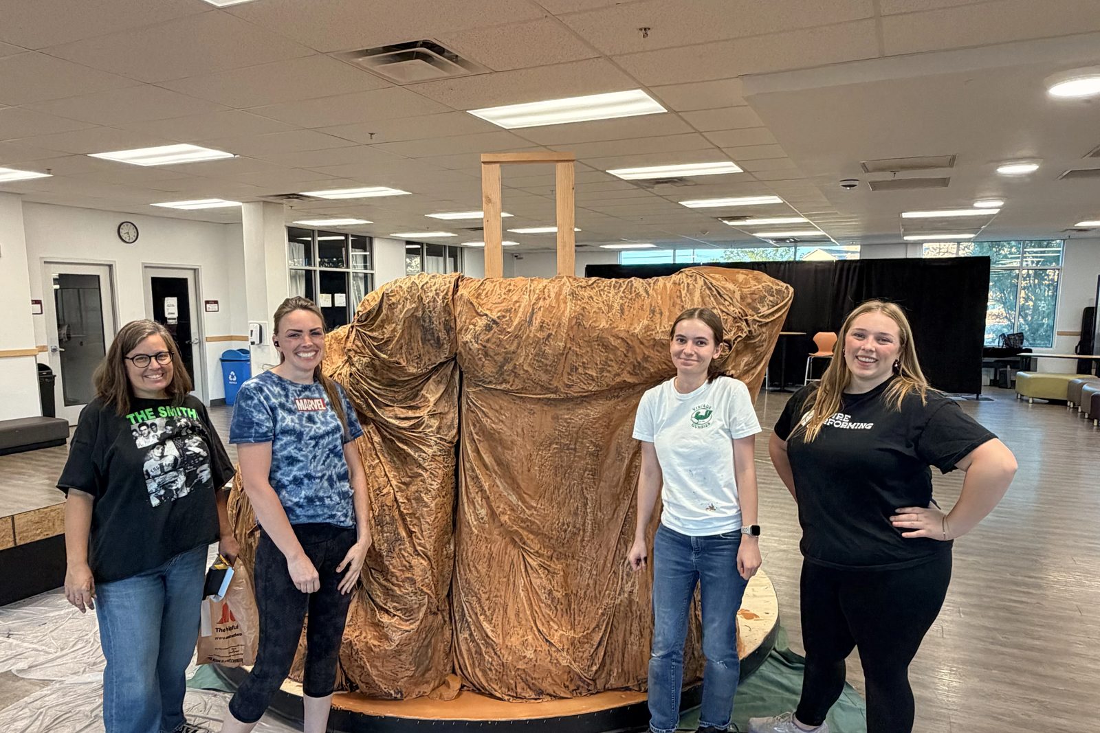 Volunteers beside the Pride Rock set piece during a work day