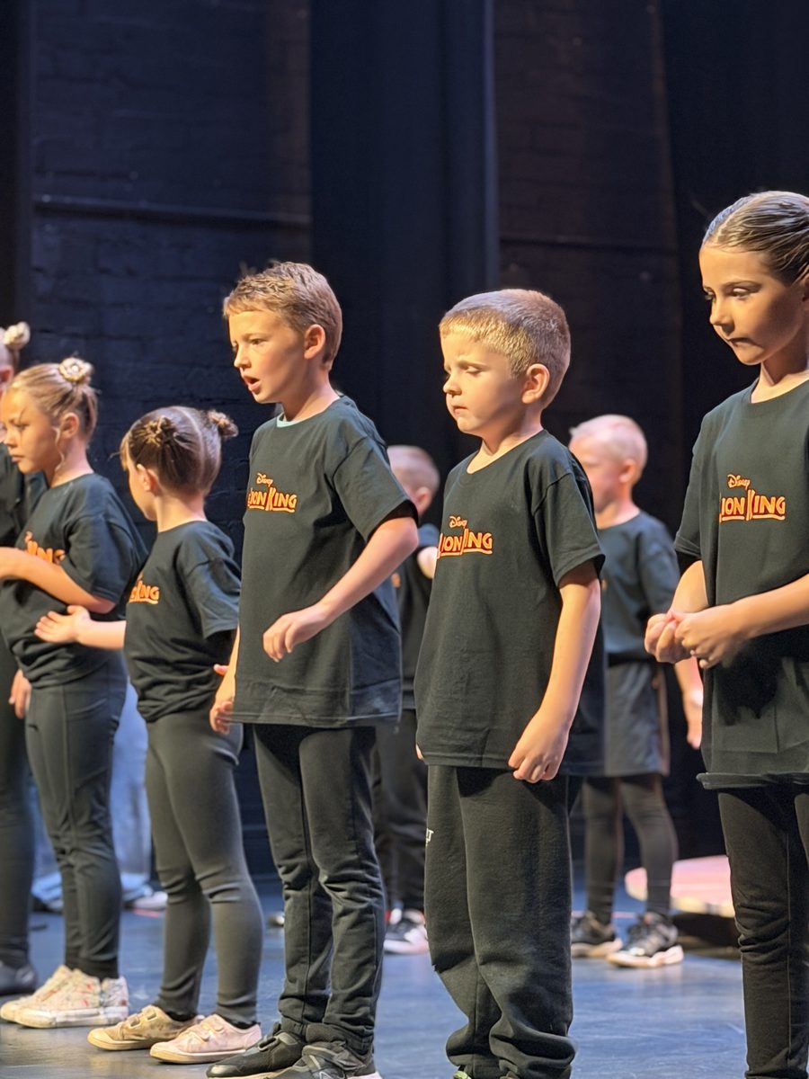A line of Young Artists performing on stage