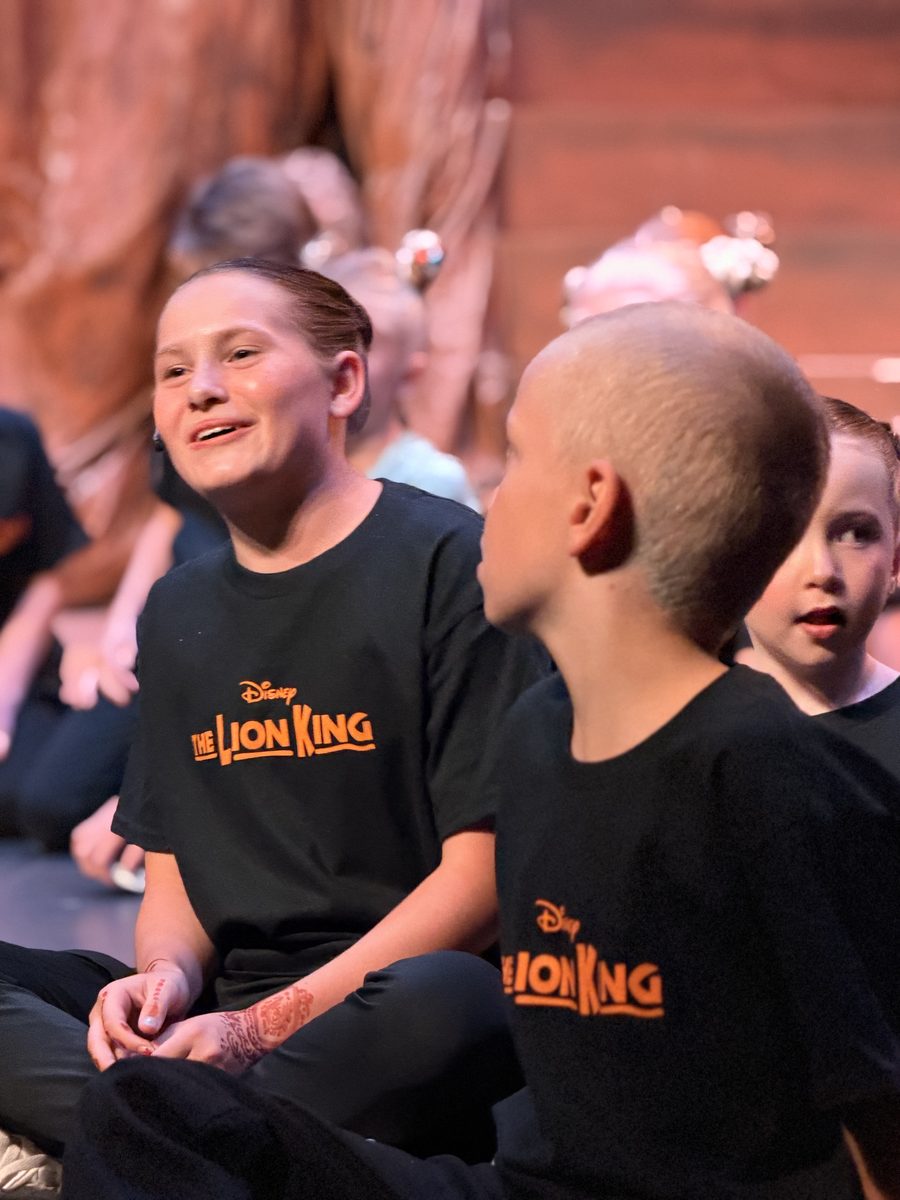 Two Young Artists sharing a laugh on stage