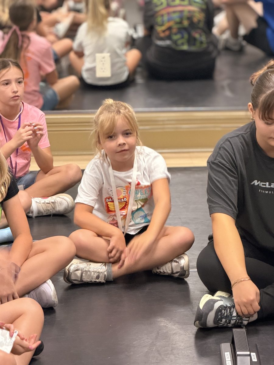 A camper sitting in the circle during a group session