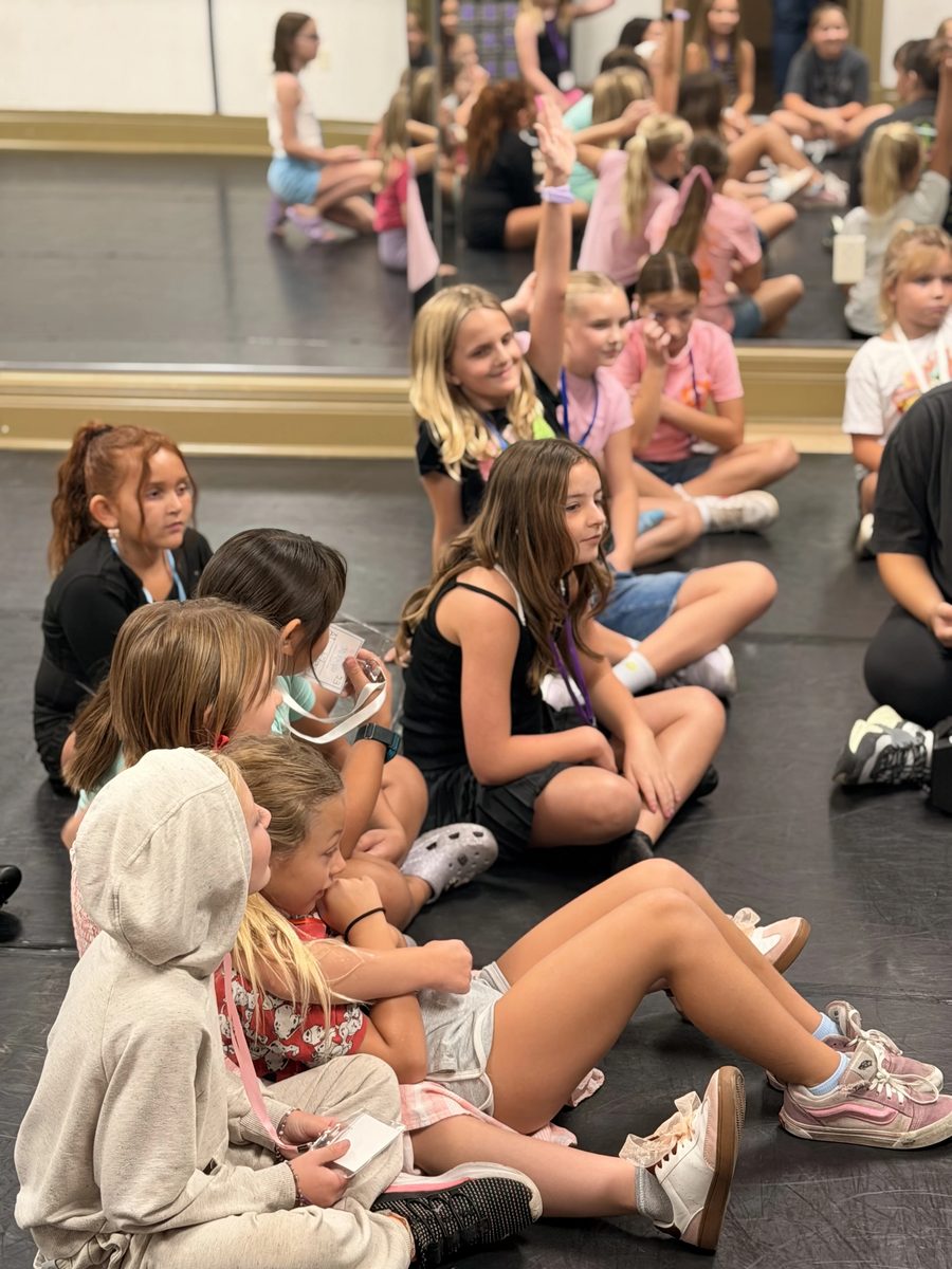Campers raising their hands during a group session