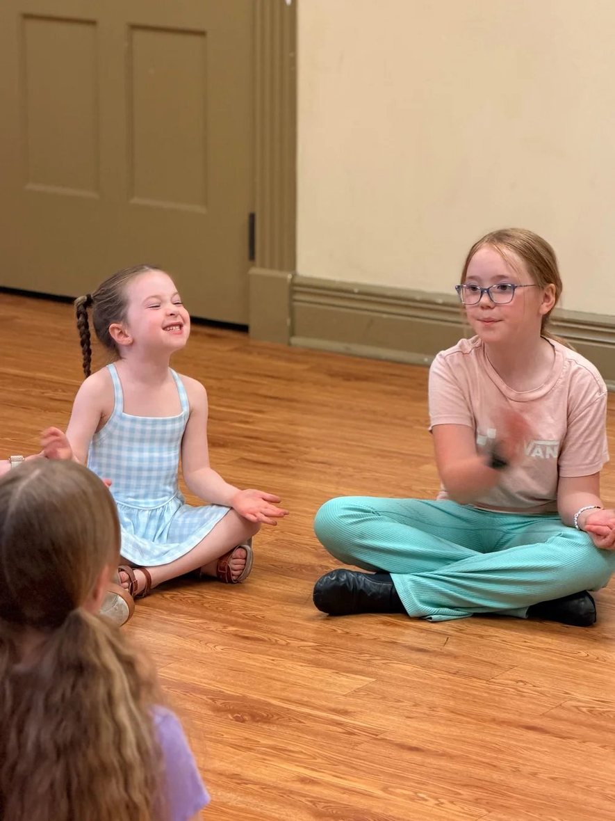 Two Young Artists laughing together during a warm-up