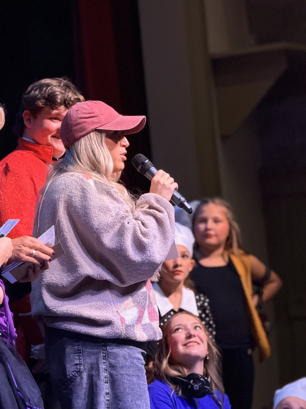 A member of the Encore team speaking to the company on stage after the final performance