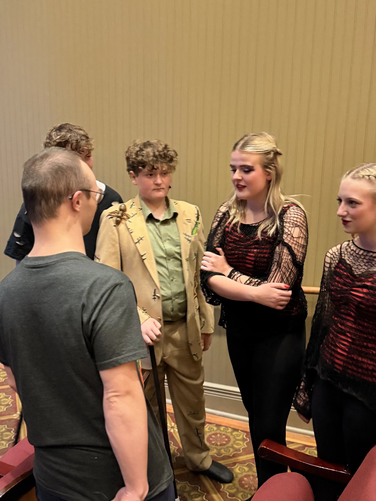 Encore Young Artists in costume talking with guests in the aisle after the performance