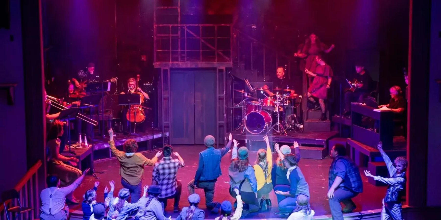 Encore Young Artists performing on the Electric Theater stage with a live band behind them