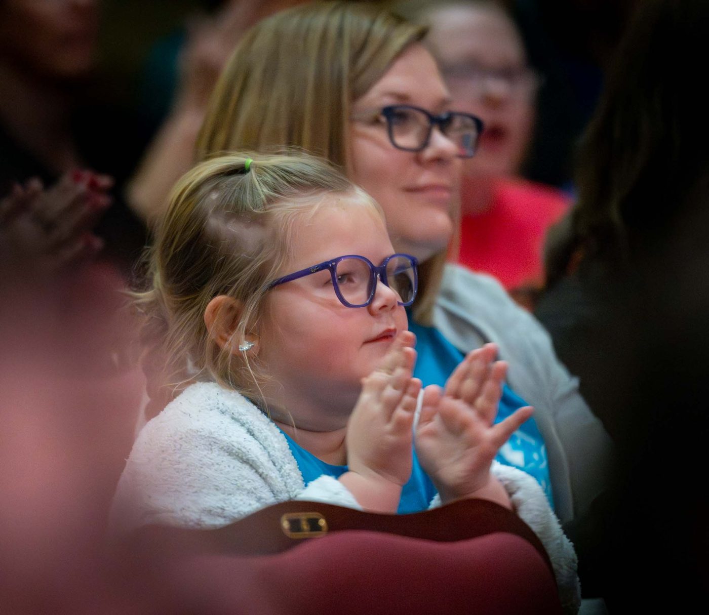 A young guest claps during an Encore performance